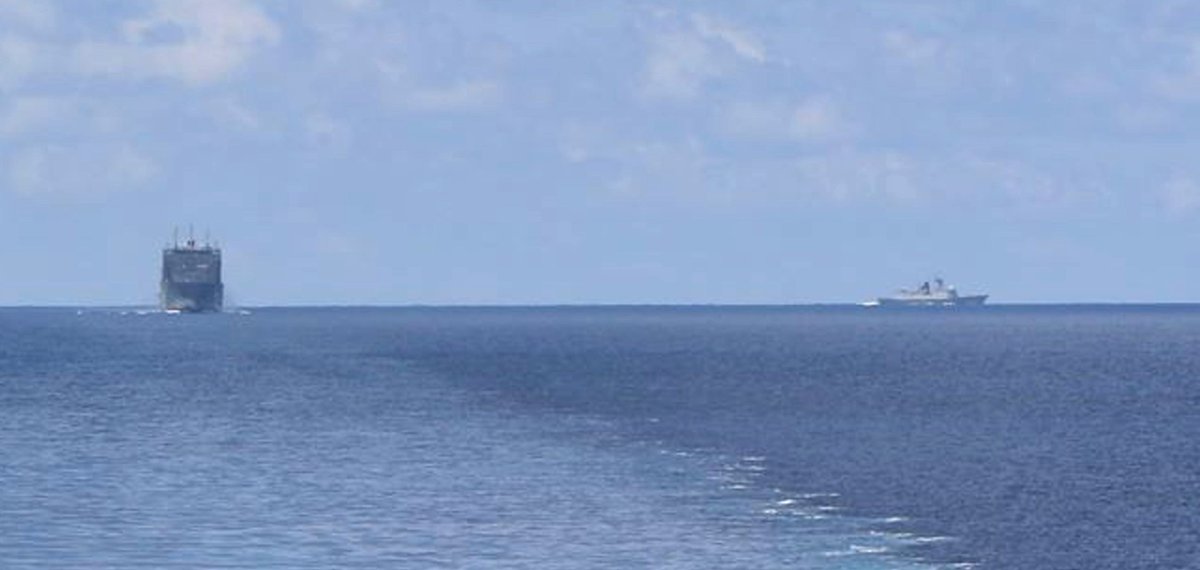 US Navy littoral combat ship MONTGOMERY LCS8, on a western Pacific deployment, cruises the South China Sea 7 May with supply ship CESAR CHAVEZ T-AKE14 astern and a Chinese Type 054A frigate shadow on the horizon 