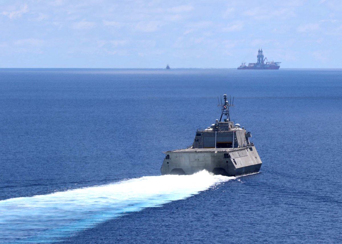 US Navy littoral combat ship MONTGOMERY LCS8, on a western Pacific deployment, cruises the South China Sea 7 May with supply ship CESAR CHAVEZ T-AKE14 astern and a Chinese Type 054A frigate shadow on the horizon 