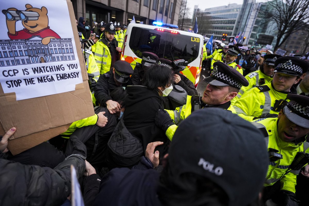 Polizisten und Demonstranten von mindestens 28 Diaspora-Gruppen – darunter Hongkonger, Tibeter, Uiguren, chinesische Dissidenten und andere ansässige Organisationen – vor dem geplanten Standort für den Umbau der neuen chinesischen Botschaft im Royal Mint Court im Zentrum Londons.